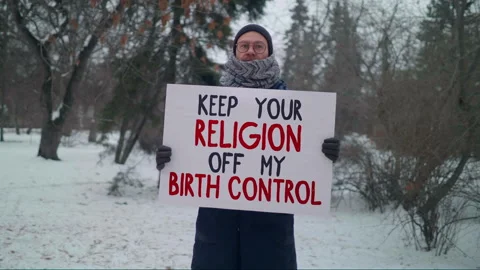 A person in a single picket with a Banner Keep My Religion Off My Birth Control Stock Footage 169515784