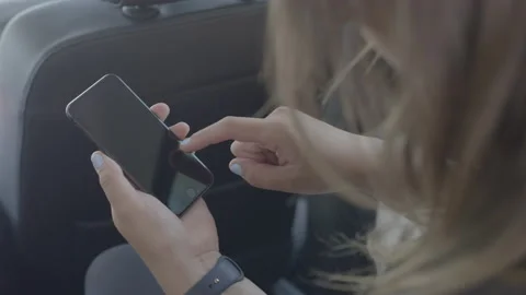 Person sitting in car using cellphone Stock Footage 134582869