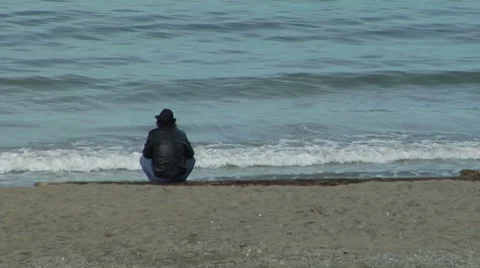 Person sitting down by the water Video stock 8670899