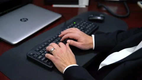 A person sitting in front of a keyboard Stock Footage 155533700