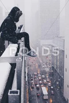 Person Sitting On The Ledge Of A Skyscraper