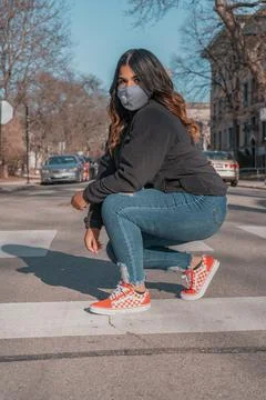 Person sitting on the street posing Stock Photos