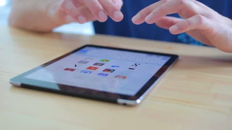 A person sitting at the table and using a touchpad Stock Footage 91357857