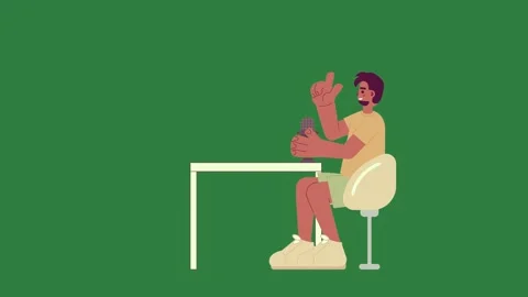 A person sitting at table with cell and in their hand desk green background Video stock 335122603