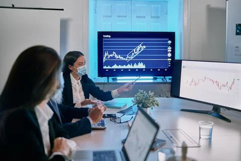 A person sitting at a table in front of a computer Stock Photos