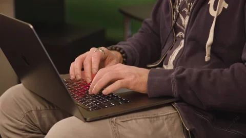 A person sitting at a table using a laptop Stock Footage 155536232