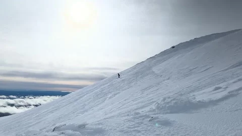 A person skiing down a steep slope on the mountain in winter. Stock-Footage 220240147