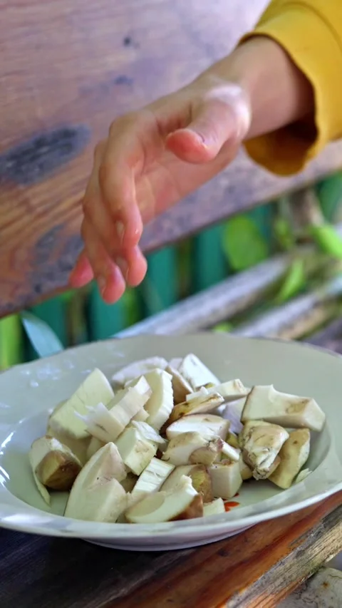 A person skillfully peeling mushrooms while making a delicious vegetable stirfry Stock Footage 321611818