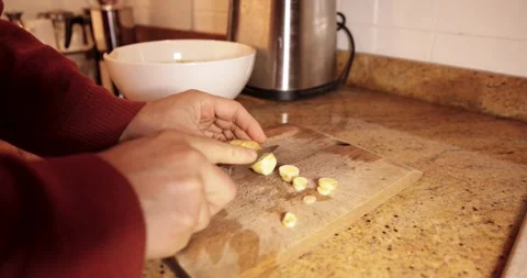 Person slicing fresh ginger root on cutting board Stock Footage 333237503