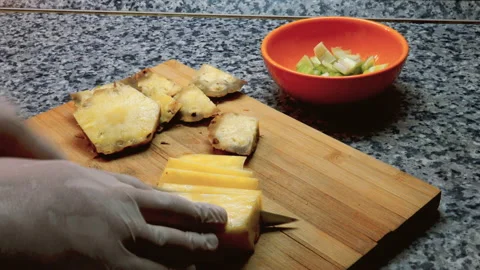 A person is slicing pineapple fruit Stock Footage 141160334