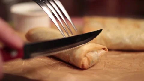 Person slicing a spring roll. Stock Footage 144219641