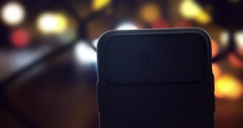 A person sliding a camera cover on an iPhone Video stock 138477302
