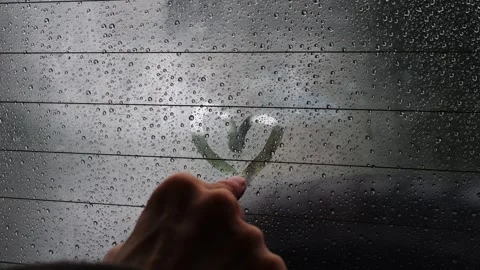 Person slowly draws a heart shape on a foggy, rain-covered... Stock Footage 339101468