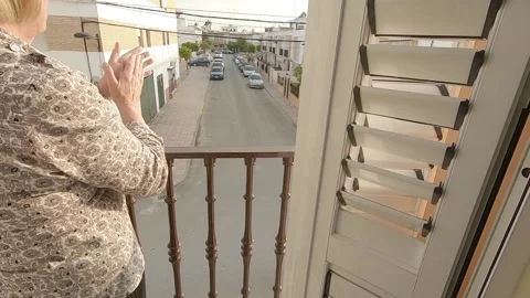 Person in Spain clapping on the balcony every day in support of workers and p Stock Footage 136097403