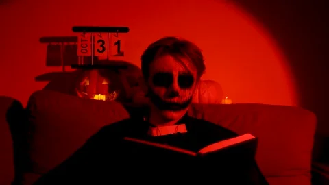 A person with a spooky skull-like face getting into the Halloween spirit. Stock Footage 319825685