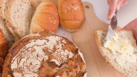 Person Spreading Butter on Multigrain Bread Slice Video stock 337767690