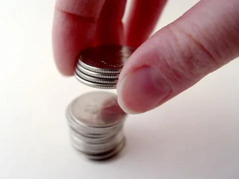 Person stacking coins Stock Photos