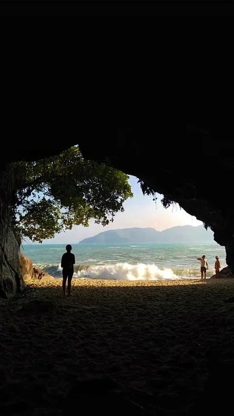 A person stand in front of Gruta do choro cave, close to atlantic ocean in Ubatu Stock Footage 155605719