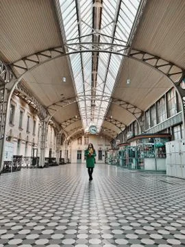 A person stand at a train station Stock Photos