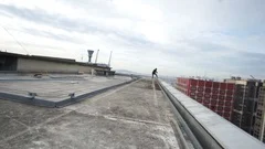 Man needlessly standing on roof overlooking cyberpunk city posing