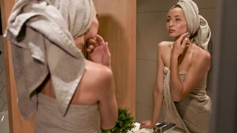 A person standing in front of a mirror posing for the camera. High quality foota Stock Footage 135137462