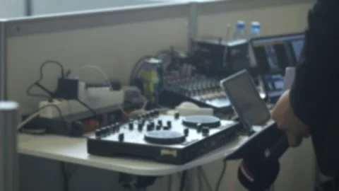 Person is standing in front of a table with a DJ mixer and other equipment Stock Footage 312378221