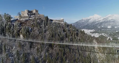 Person standing on the middle of a bridge in the Austrian Alps Stock Footage 102489377