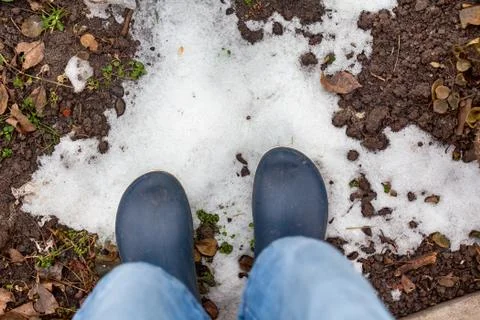 Person standing on patch of snow Stock Photos
