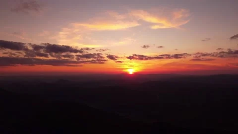 Person standing on rock with epic mountain viewpoint with a sunset drone aerial 库存影片 201166262