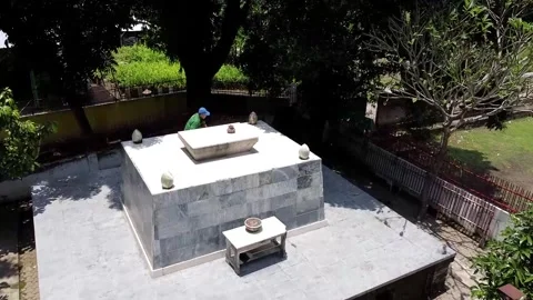 Person standing on a white stone platform outdoors - Trowulan Video stock 279655955