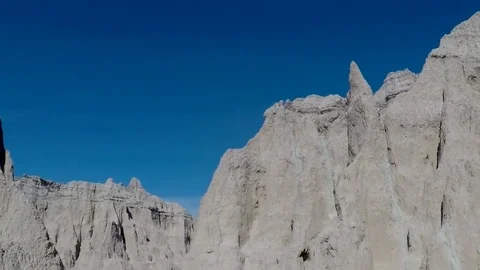 Person stands between rocky formations in the Badlands Stock Footage 81762902