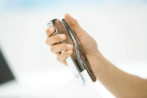 Person stapling document, cropped view of hand 写真素材