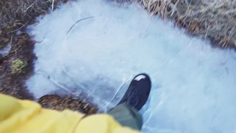 Person Stepped On And Crushed Thin Ice On The Ground At Winter. - POV Video stock 151009110