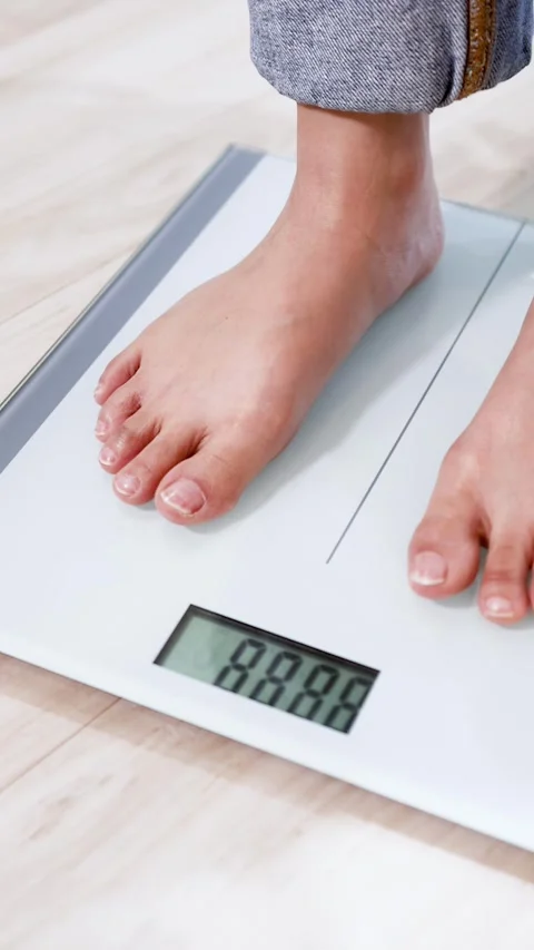 Person Stepping on Digital Bathroom Scale to Check Body Weight Stock Footage 334092819