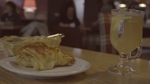 Person stir ginger tea in cafe. Breakfast morning croissant Stock Footage 85631470