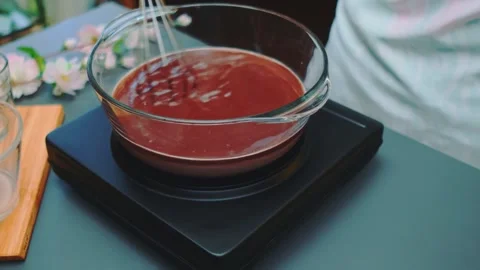 Person stirring chocolate mixture in glass bowl in kitchen 스톡 동영상 342862425