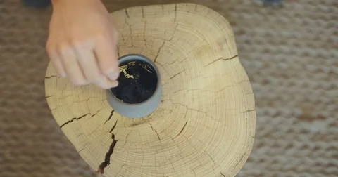 Person Stirring Drink In Cup On Tree Stump Stock Footage