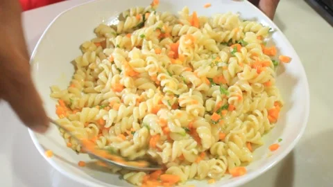 A person stirring macaroni dough. making macaroni dishes Stock Footage 334647270