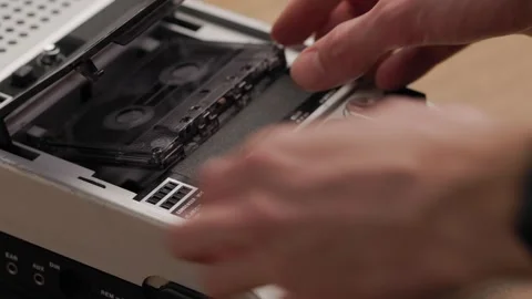 Person stops playback and ejecting cassette from vintage tape recorder Video stock 303138979