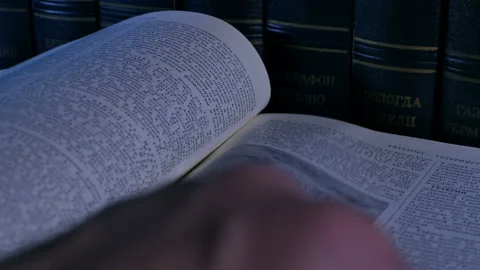 Person studies the text of the opened book Stock Footage 102458929