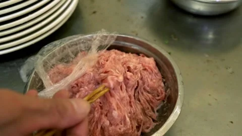Person stuffing tofu with meat to make stuffed tofu on plate Video stock 131145410