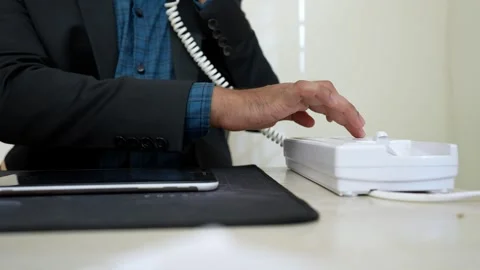 Person in a suit typing on a tablet, with a stapler nearby on a desk Stock Footage 318057119