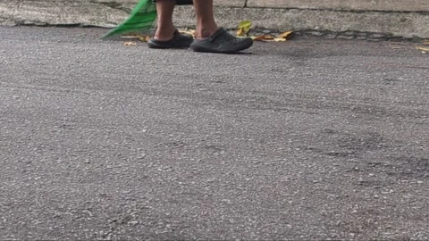 A person sweeping dry Stock Footage 330574377