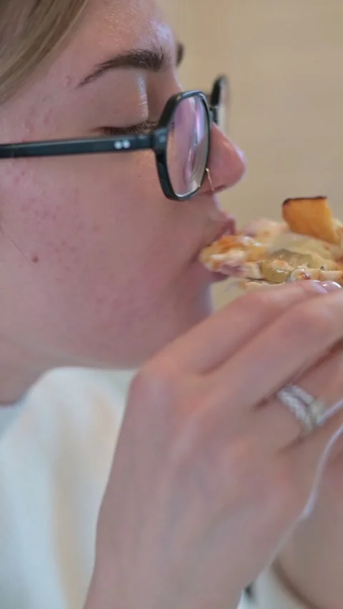 A person takes a bite of a sandwich, showcasing close-up details of the food. Stock Footage 337556221