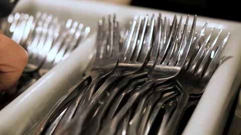 Person takes fork from stack fo silverware Stock Footage 94232002