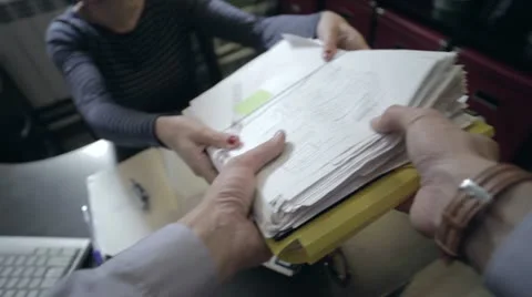 Person takes a stack of documents Stock Footage