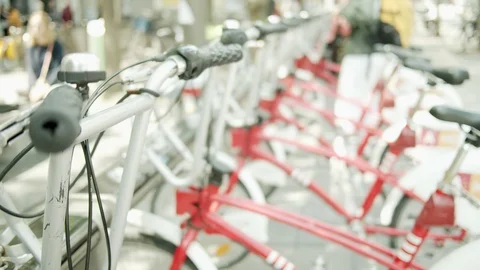 Person taking and using bike in a city from a bike rental stand Video stock 110924009