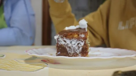 Person taking a bite of sweet cake with spoon on plate Stock Footage 342455720