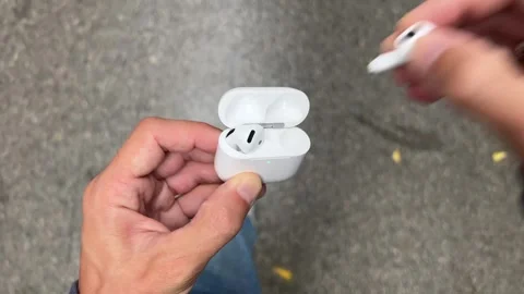 Person Taking Out Wireless Earbuds from a Case Stock Footage 317004103