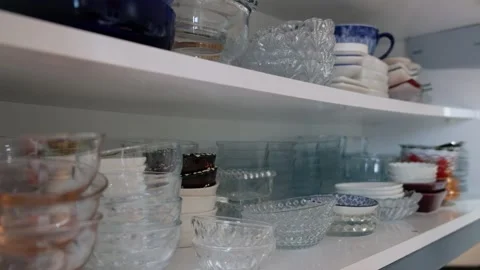 Person Taking Small Serving Plates from a Two-Shelf Kitchen Cabinet Stock Footage 302688162
